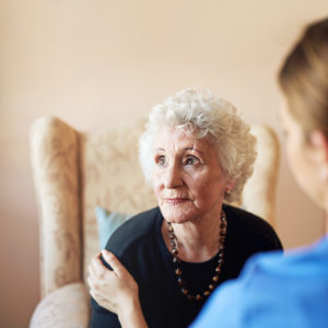 assisted living memory care nurse caring for an elderly woman